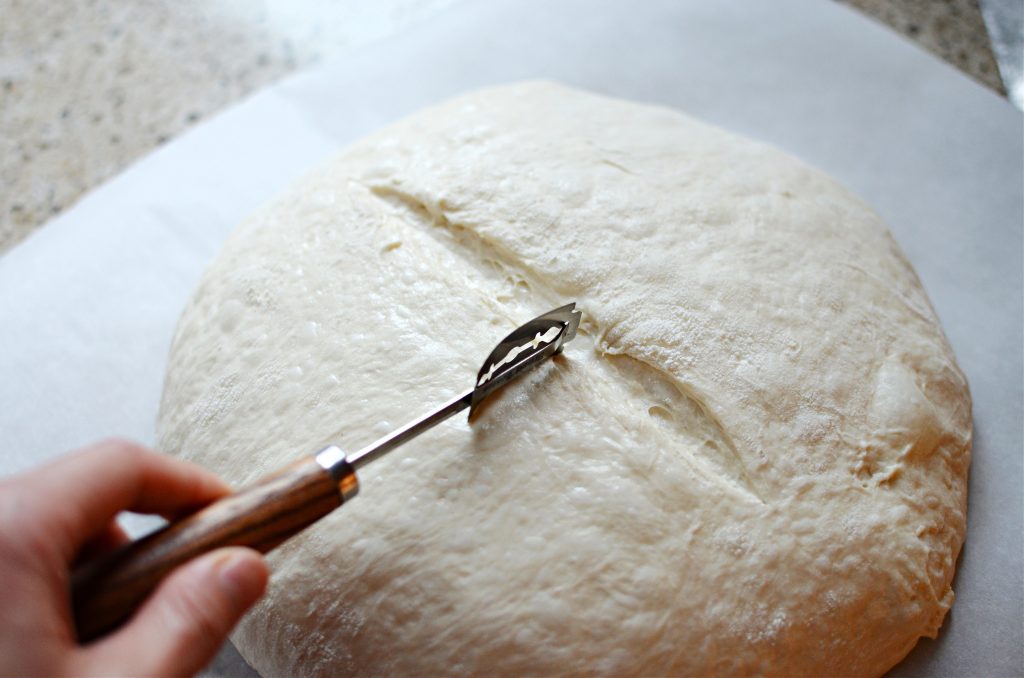 scoring sourdough bread with lame