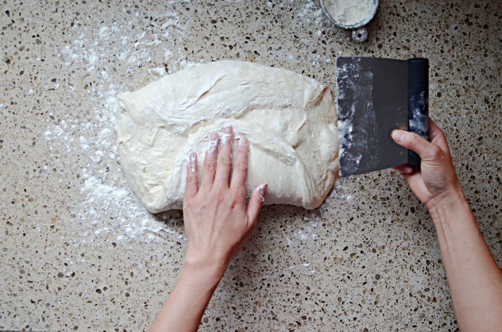 sourdough being shaped on counter