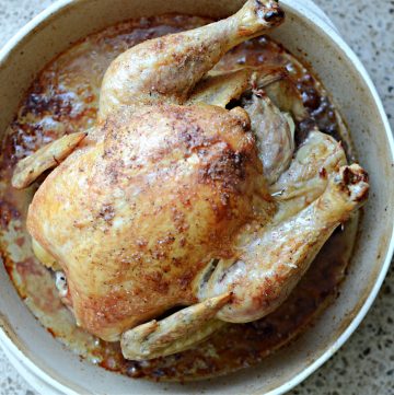 Roast chicken in round stoneware pan