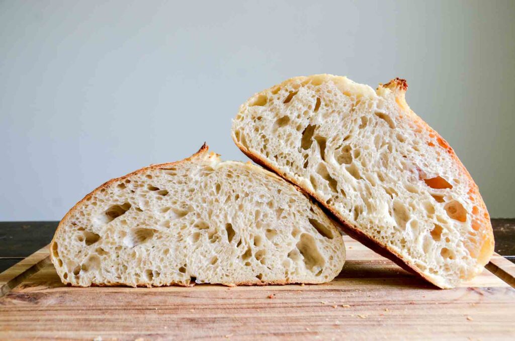 cut loaf of sourdough bread stacked on top on of one another
