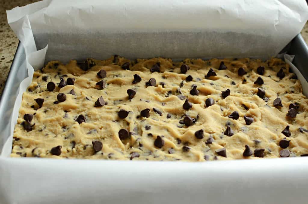 Chocolate chip cookie bar dough in 9X13, lined with parchment paper