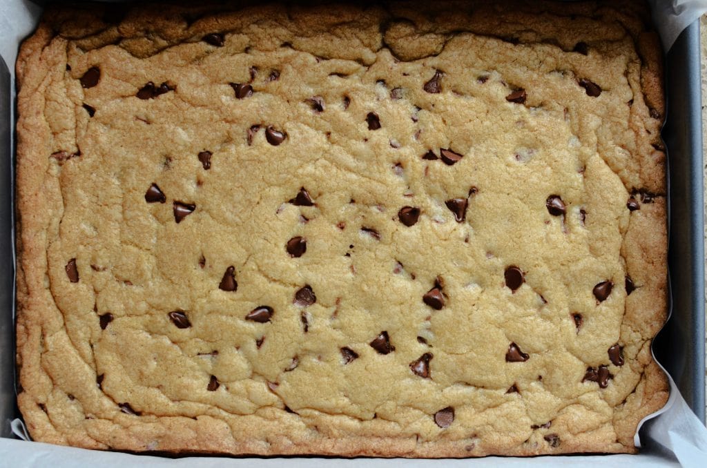 Baked chocolate chip cookie bars in metal 9x13 pan