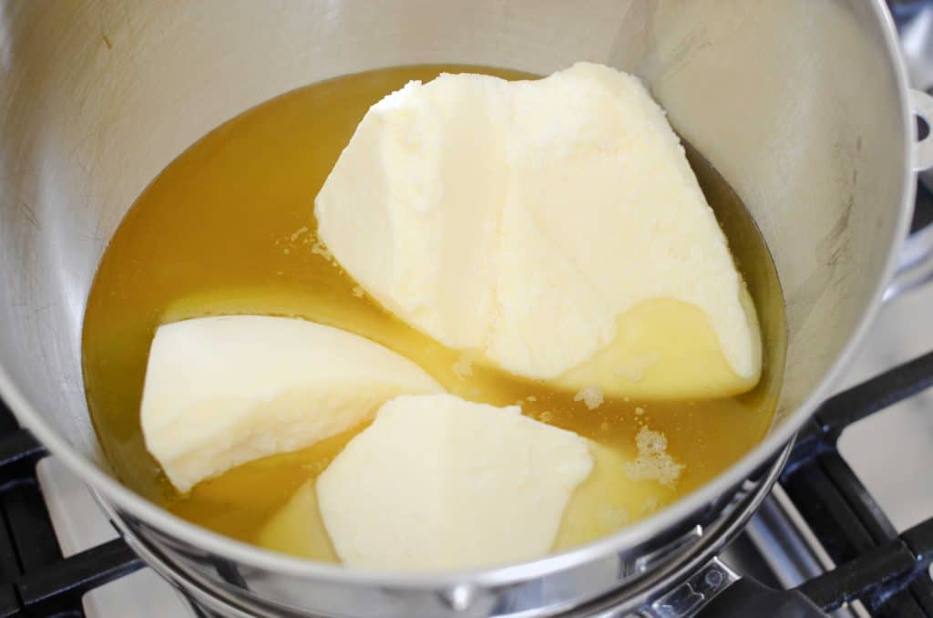 Melting beef fat in metal bowl over pan of water