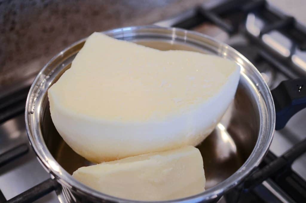 Large chunks of tallow in pan slowly melting.