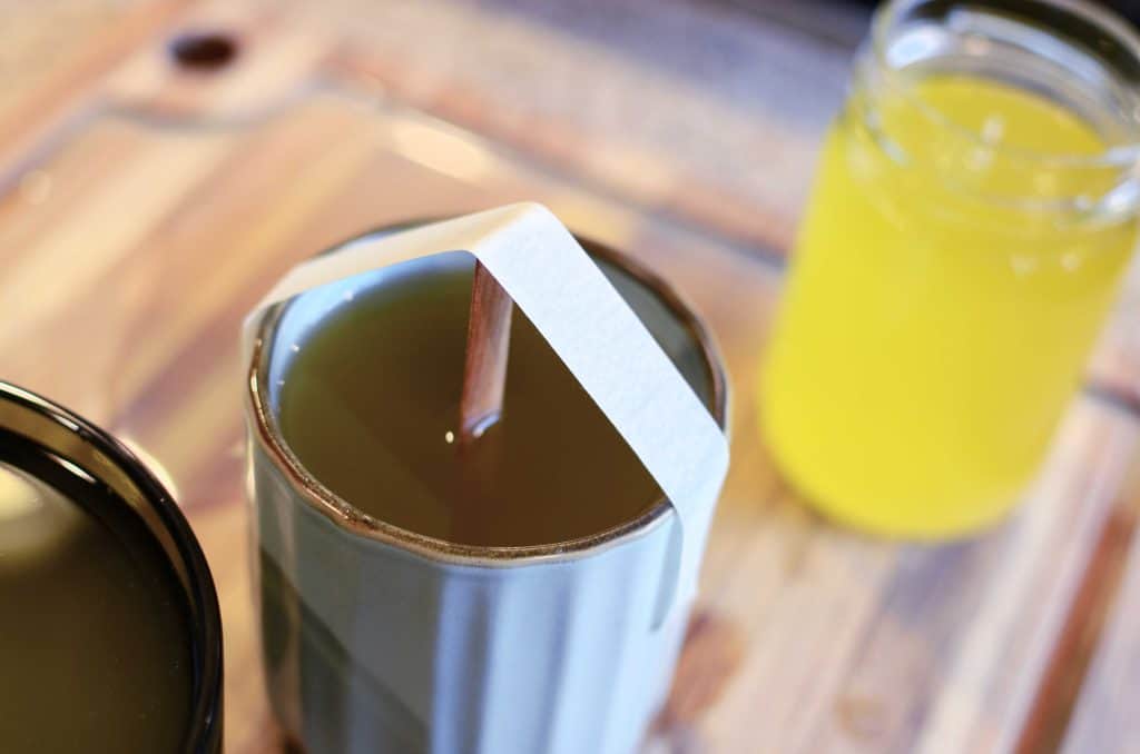 Tallow candle with wood wick held centered with tape.