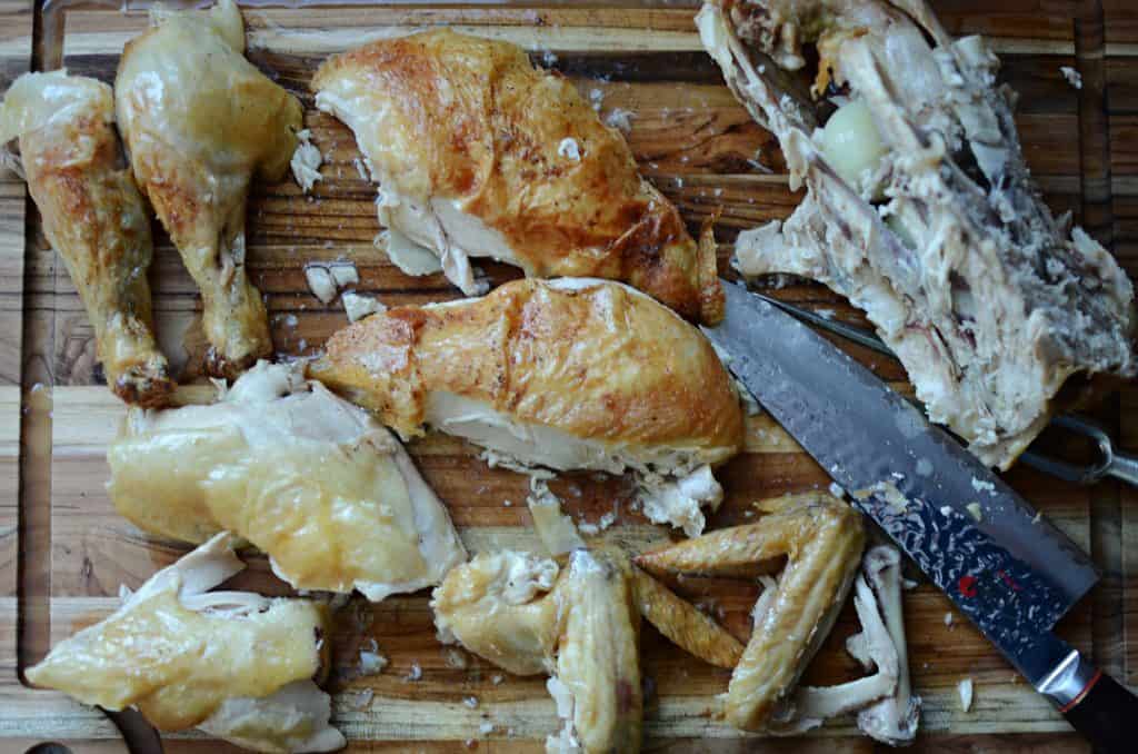 Whole chicken, cut up on wood cutting board