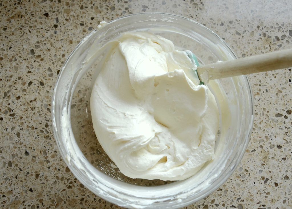 Cream cheese whipped topping in glass bowl with spatula