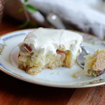 Rhubarb custard bars on plate with small bite on fork