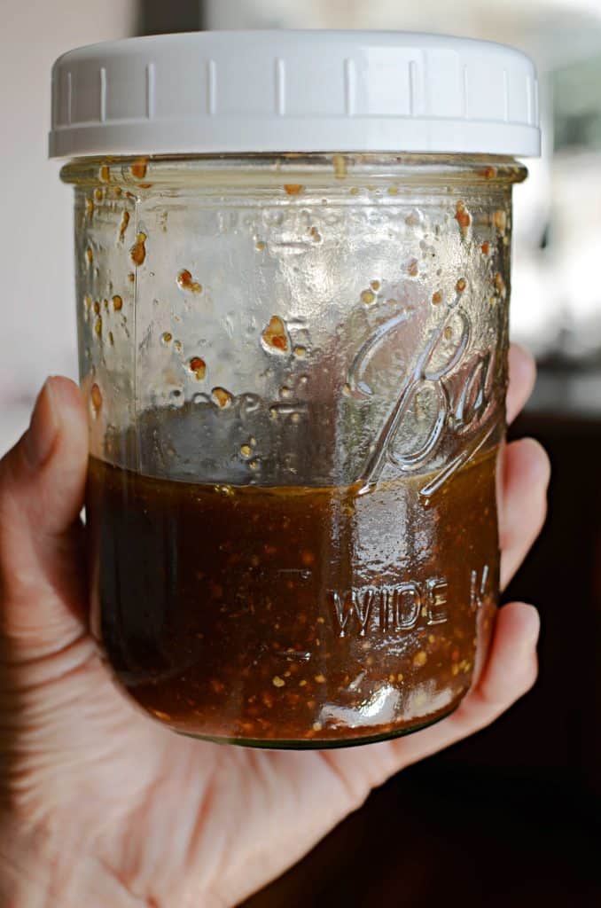 balsamic vinaigrette dressing in mason jar with white lid.