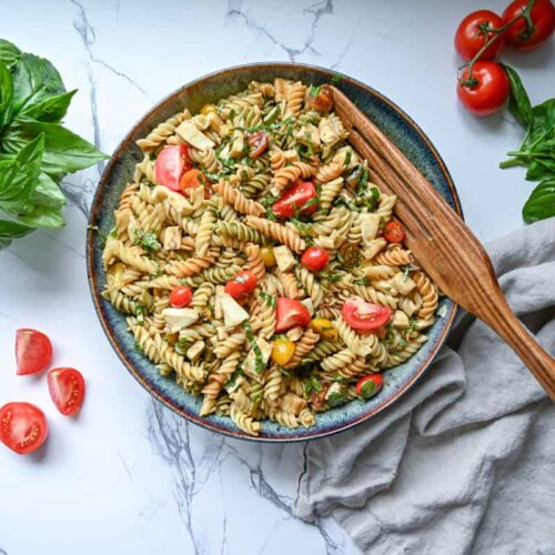 Easy caprese pasta salad in a large bowl with a wood serving spoon