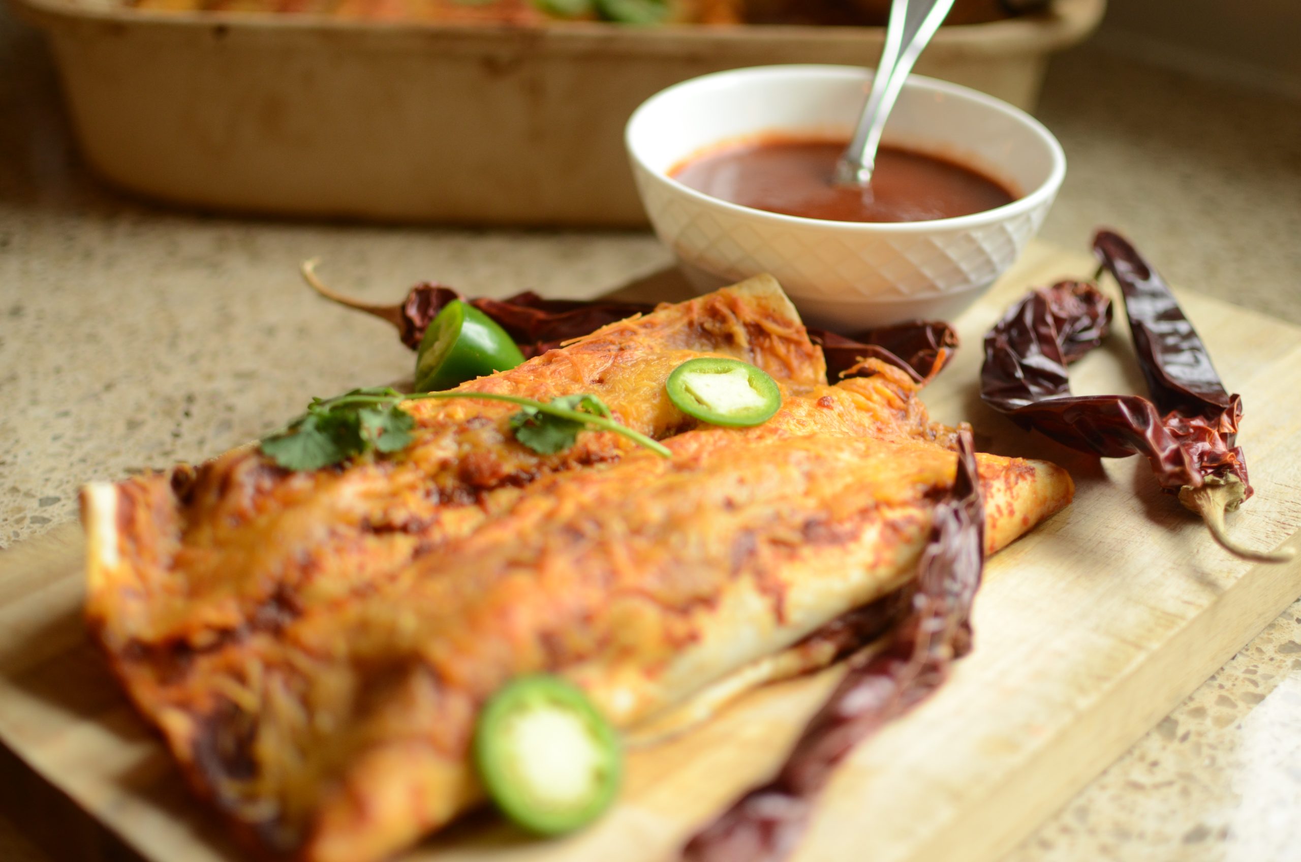 Enchiladas with dried chiles, fresh cilantro and sliced jalapeno