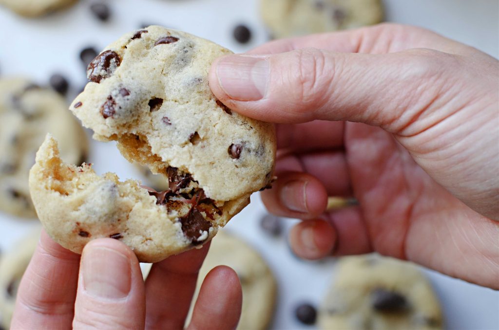 pulling apart a soft batch chocolate chip cookie 