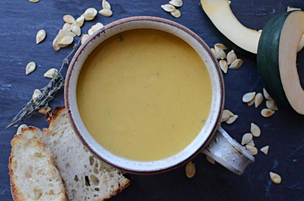 Acorn squash soup with squash seeds, and toasted bread on the side