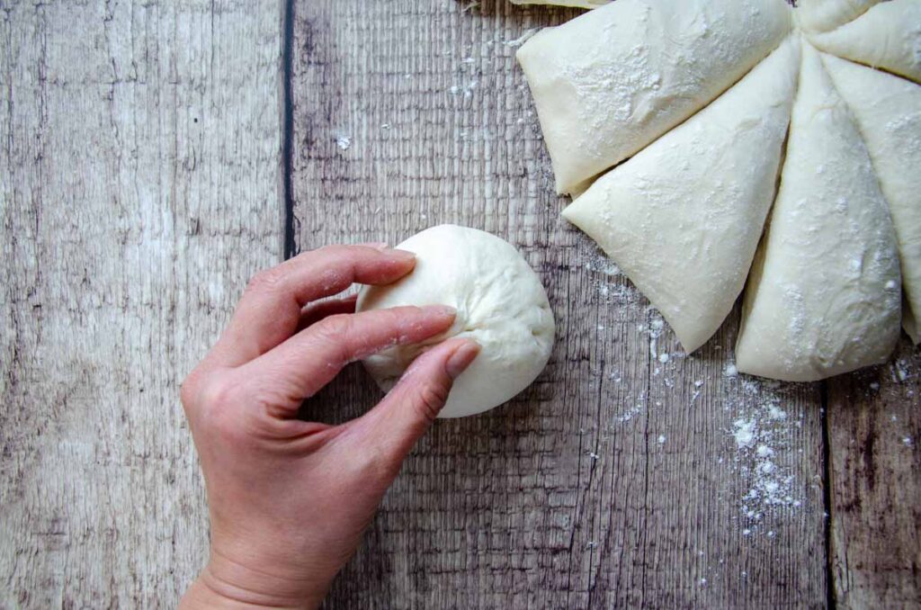 pinching the ends together to form a ball