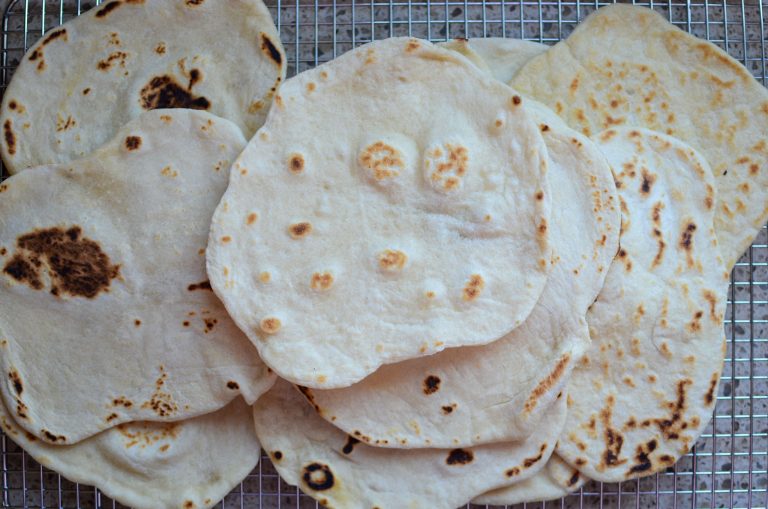 Sourdough flour tortillas on wire rack