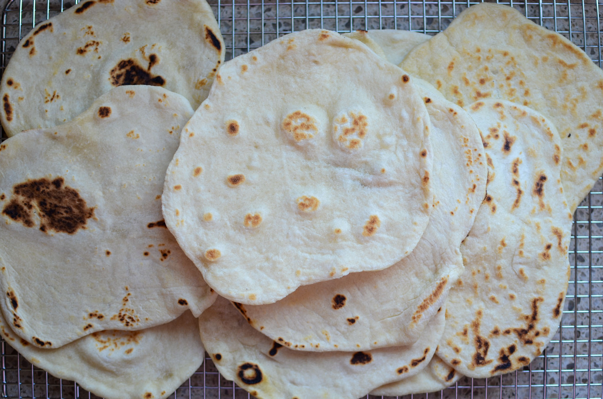 Sourdough flour tortillas on wire rack