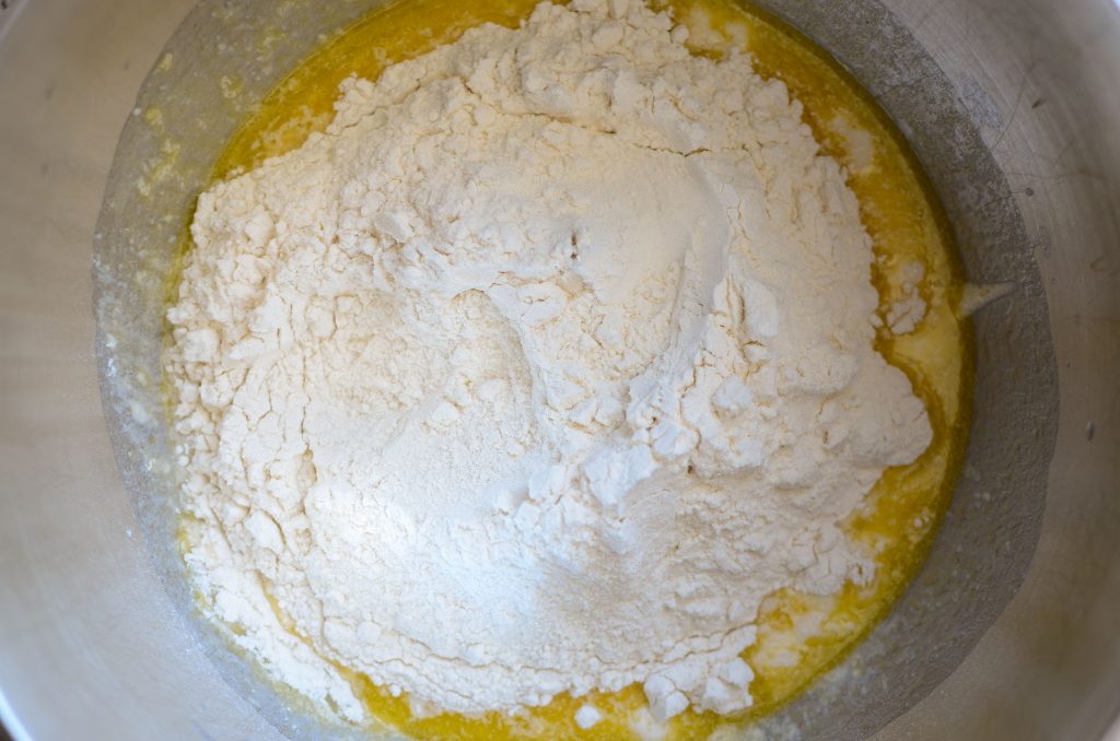 Sourdough English muffin ingredients in stainless steel mixing bowl