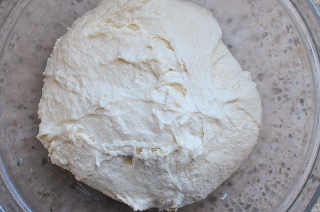 sourdough English muffin dough in glass bowl