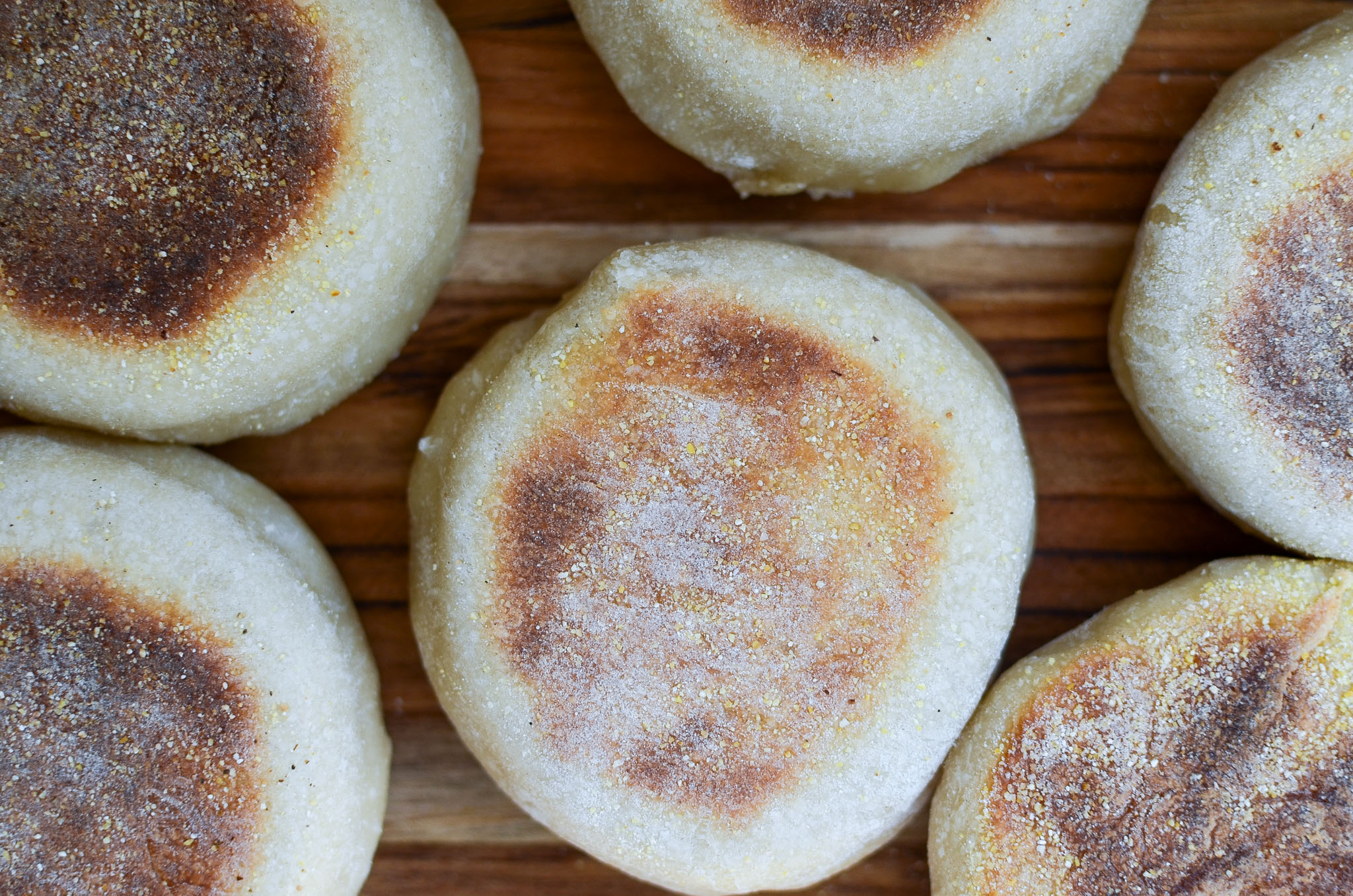 Sourdough English muffins on wood cutting board