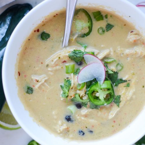 Creamy chicken poblano pepper soup with sliced radishes, jalapenos and cilantro