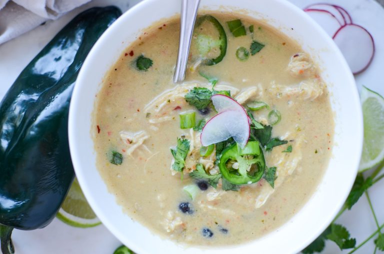 Creamy chicken poblano pepper soup with sliced radishes, jalapenos and cilantro