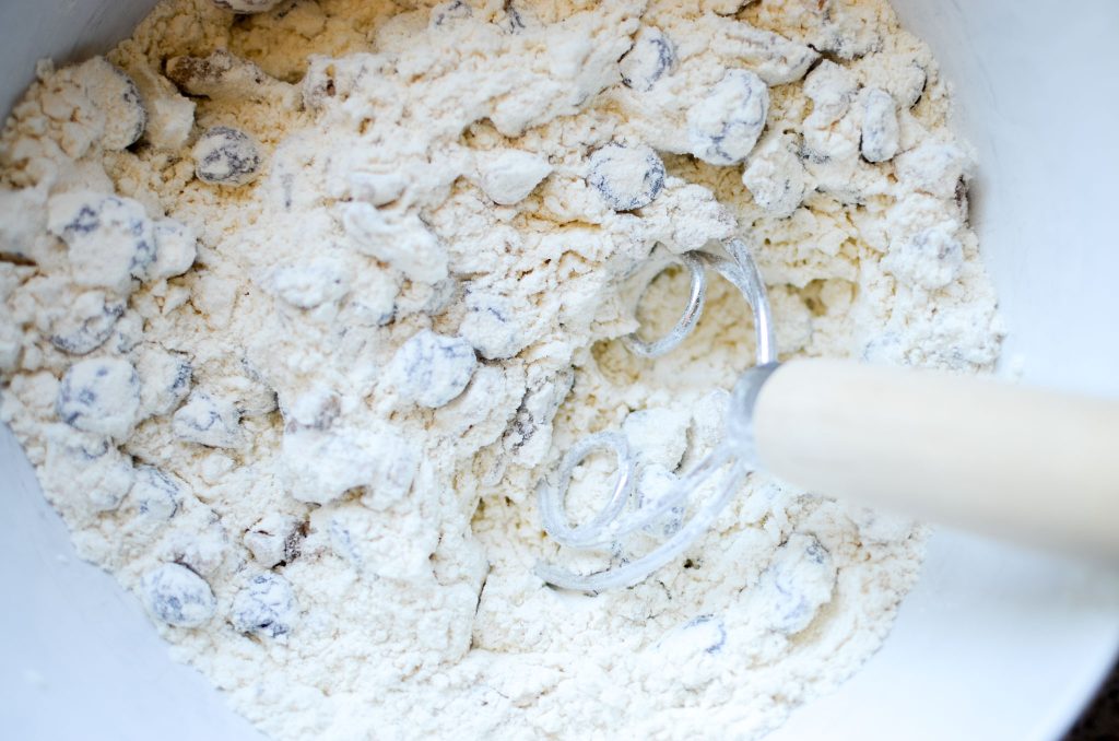 dry ingredients in bowl with dough whisk