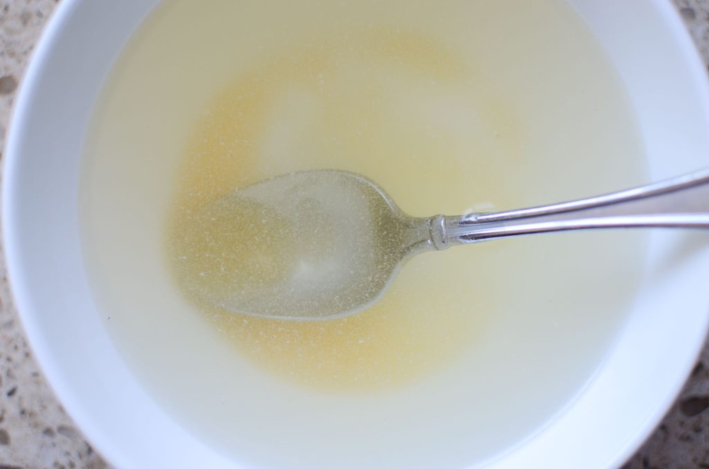 honey and water in bowl with spoon