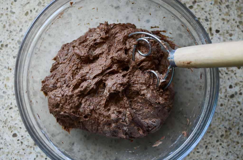 chocolate sourdough bread dough in glass bowl