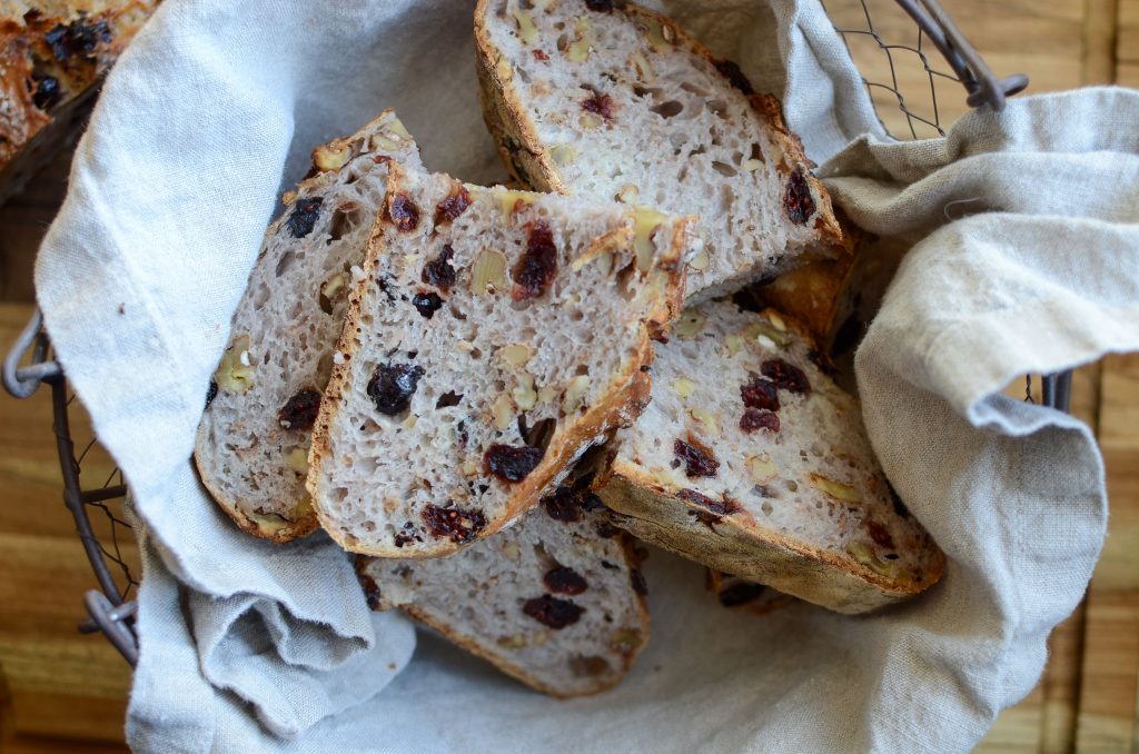 slices of cranberry walnut bread in linen lined basket