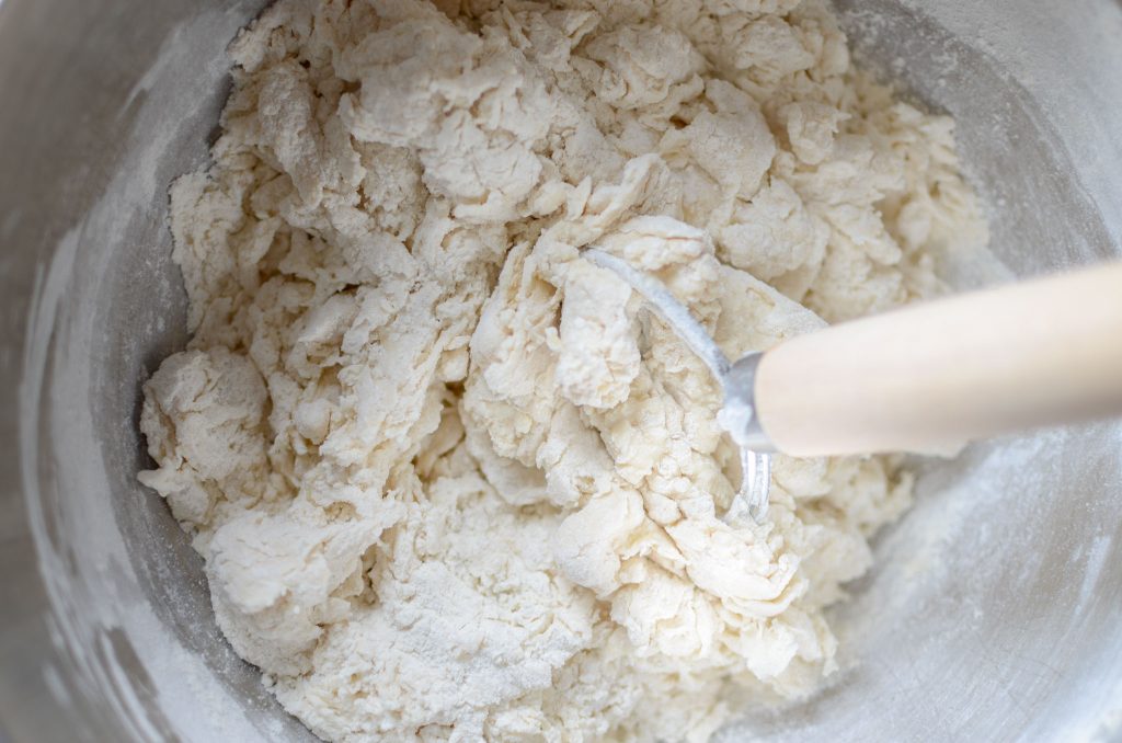 sourdough bagel dough mixed with dough whisk