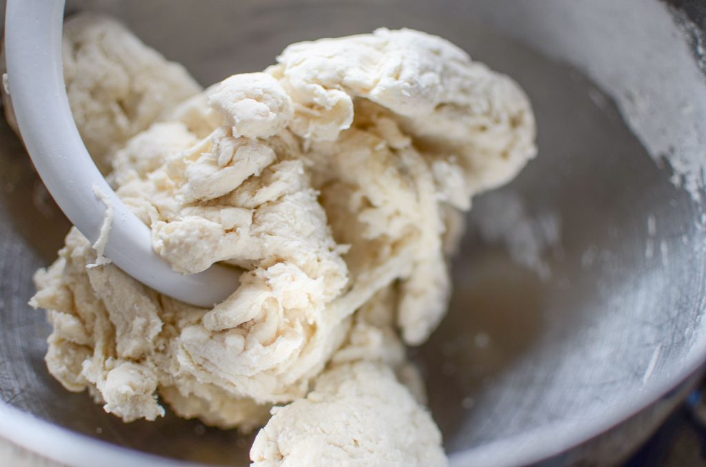 sourdough bagel dough in stand mixing bowl with dough hook