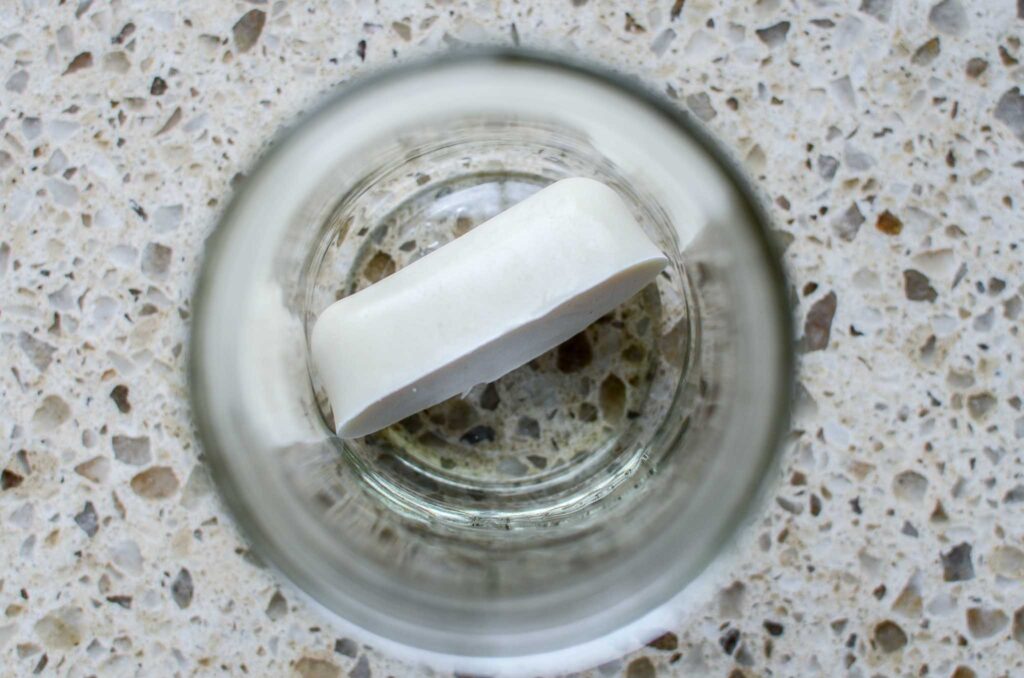 frozen cube of sourdough discard in glass jar