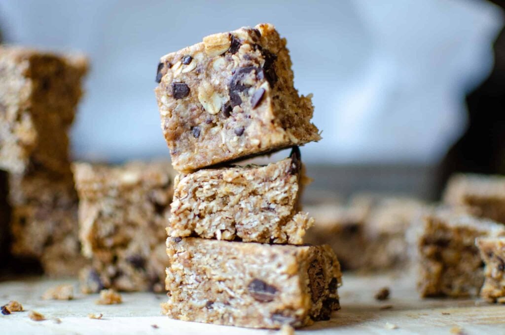 Bite-size heavenly hunk copycat bars stacked on wooden cutting board