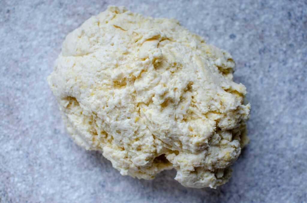 a ball of ricotta gnocchi dough on lightly floured counter