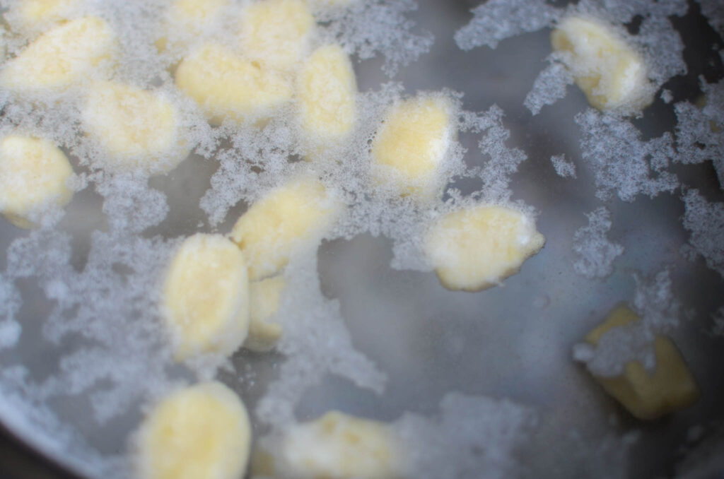 ricotta gnocchi cooked in a pot of water