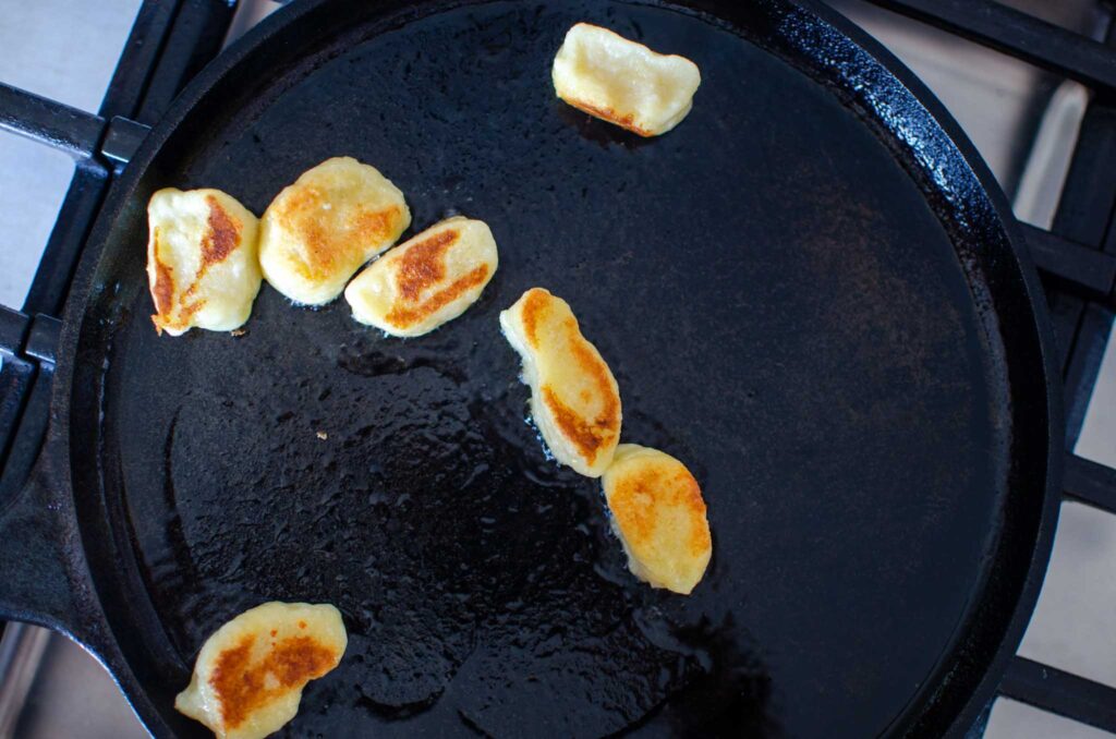 pan fried ricotta gnocchi in olive oil in cast iron skillet