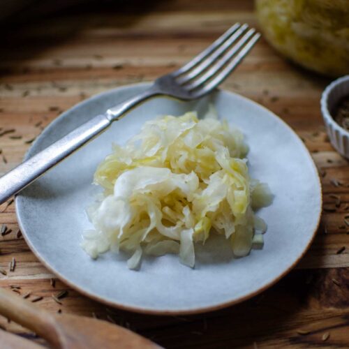 a plate of Probiotic Rich Homemade Fermented Sauerkraut with fork