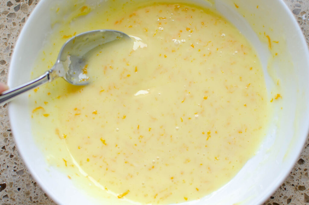 mixed sweet orange glaze in a bowl with a spoon