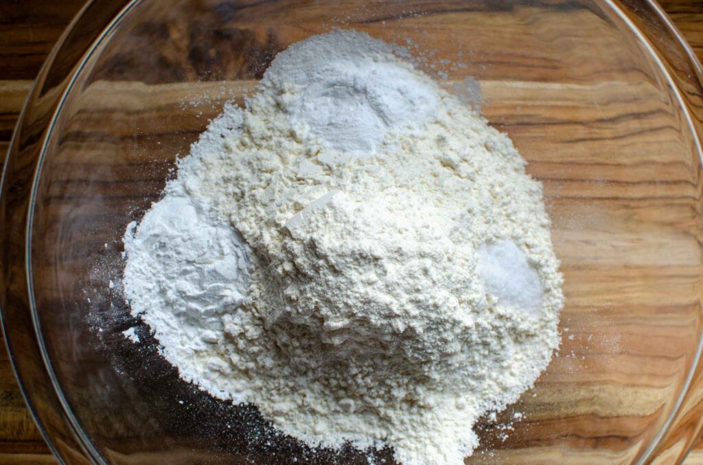 Dry ingredients in glass bowl for sourdough blueberry muffins