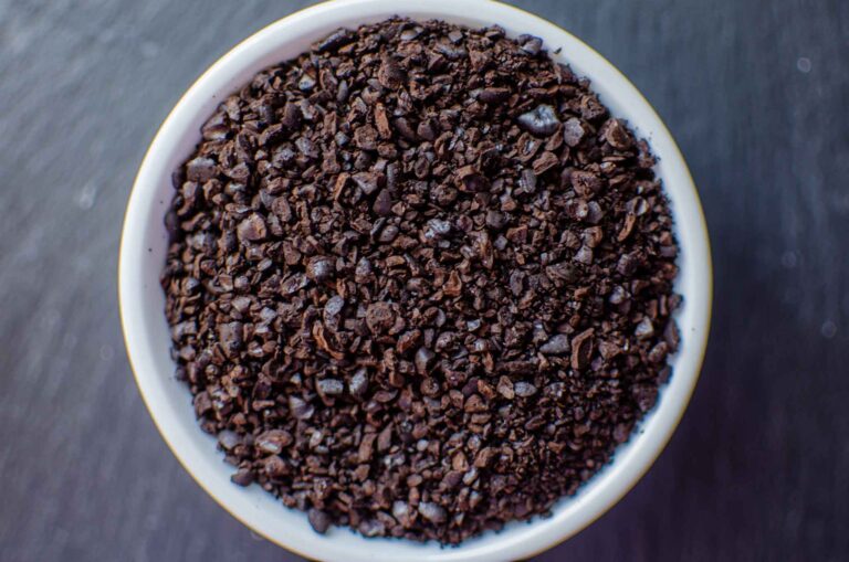 Coarse ground coffee beans in white dish