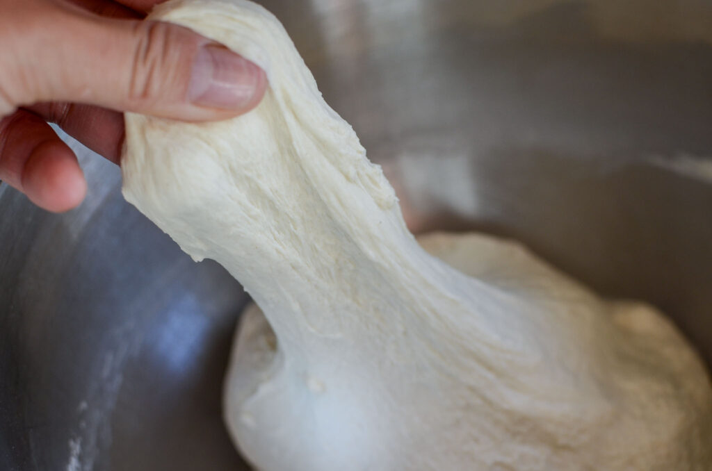 sourdough pizza dough looking smooth when stretched