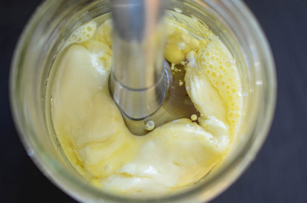 no sugar homemade mayo ingredients in a mason jar continuing to blend