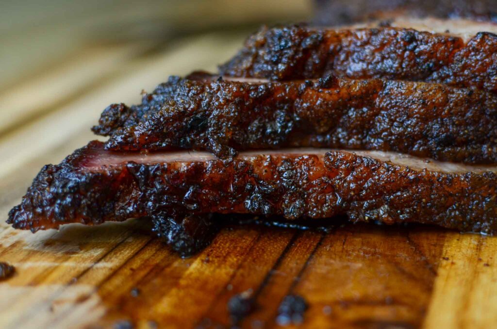 slices of smoked beef brisket stacked on top of one another