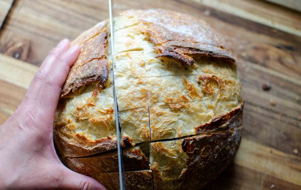 cuts going the other direction in a loaf of easy sourdough cheese and garlic pull apart bread