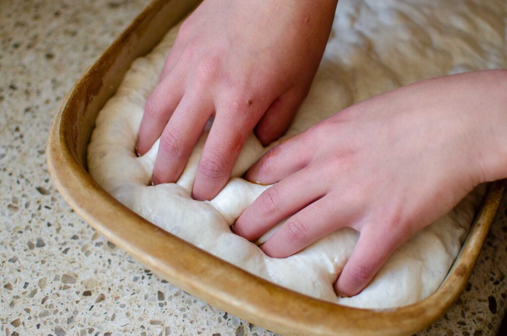 dimpling sourdough cinnamon roll focaccia dough