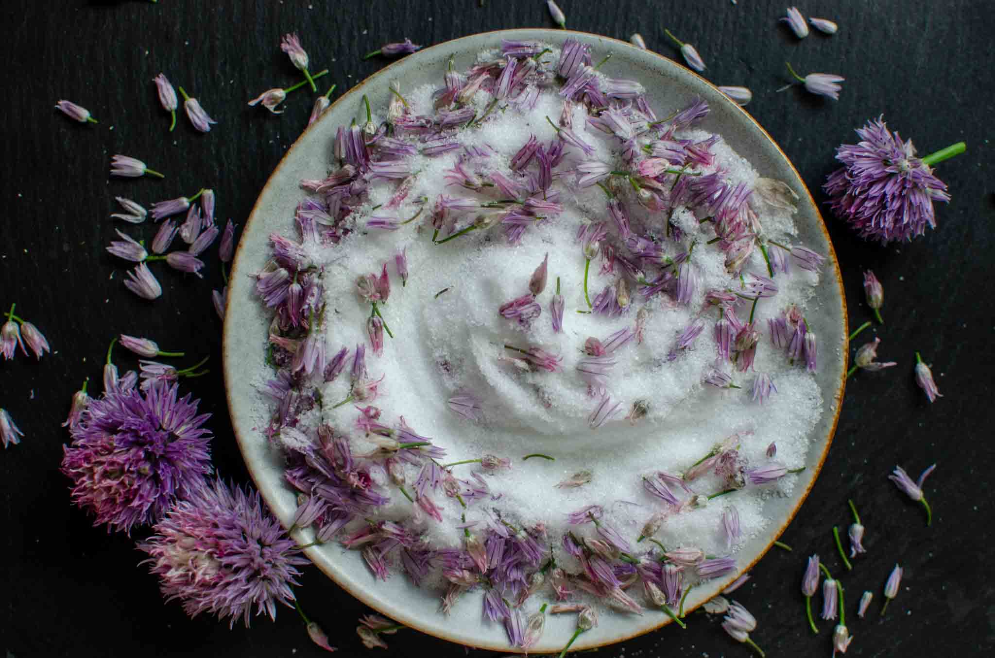 Chive blossoms mixed with salt on a dish