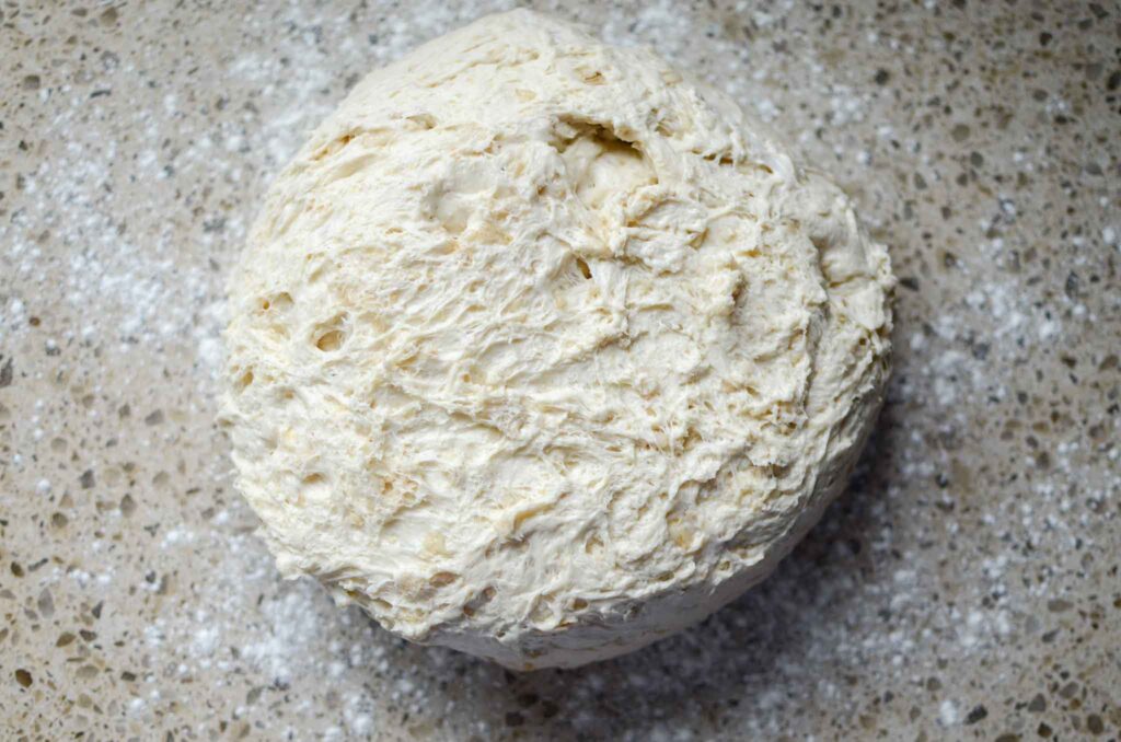 sourdough oatmeal dinner rolls dough on lightly floured work surface