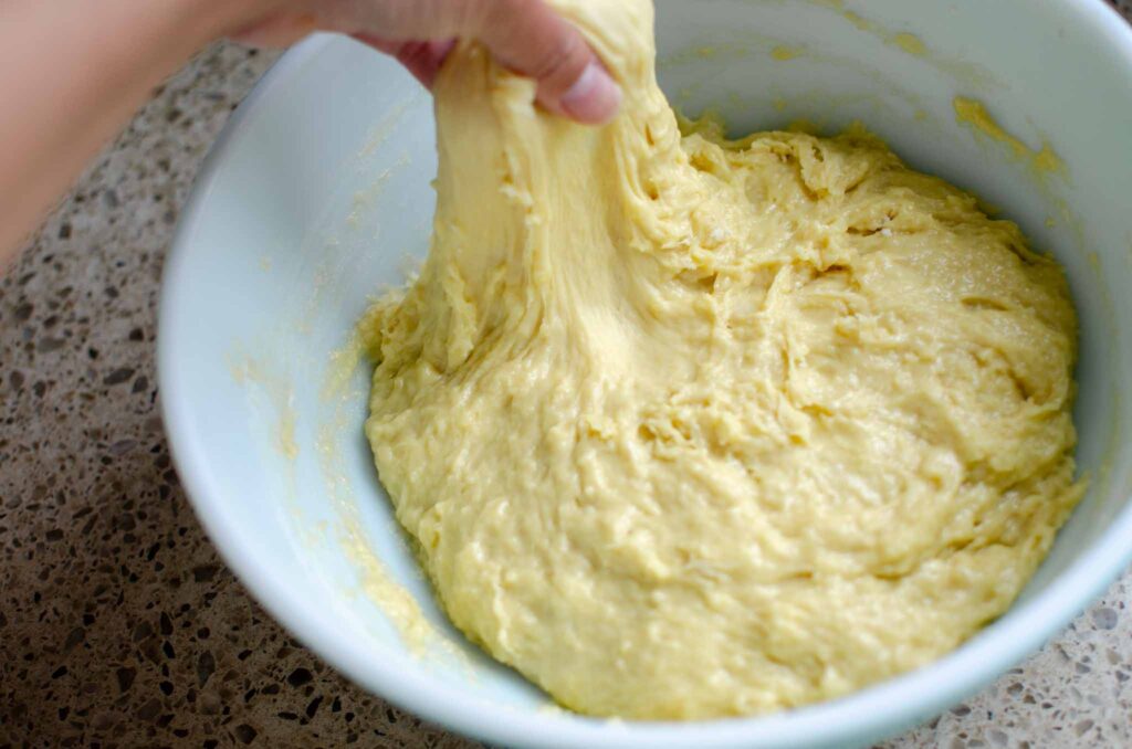 stretching dough for homemade sourdough cinnamon rolls