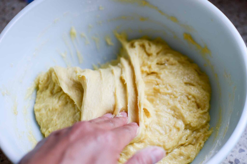 Folding over the homemade sourdough cinnamon rolls dough