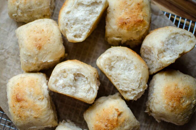 Sourdough oatmeal dinner rolls on a piece of parchment paper